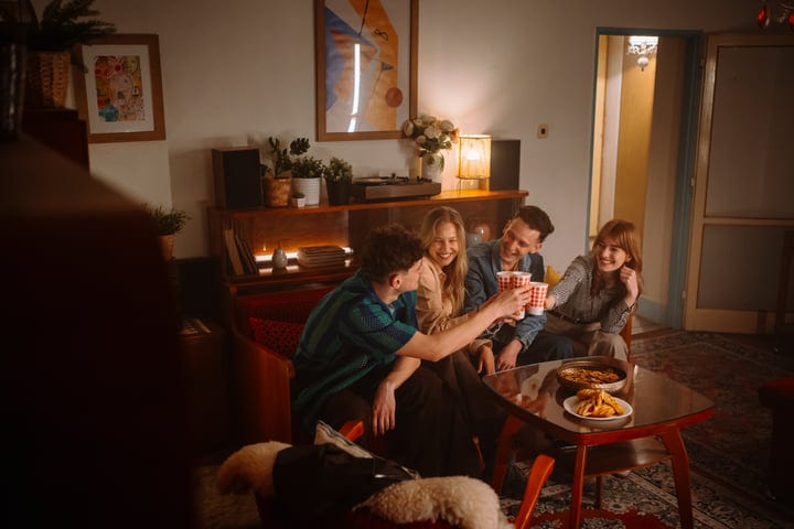 Warm Laughter And Toasts In A Cozy Living Room