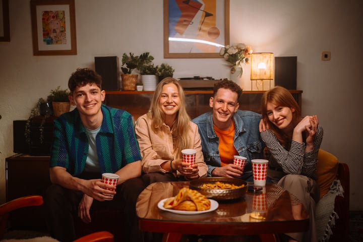 Laughter And Warm Drinks In A Cozy Living Room