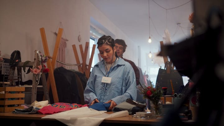 Browsing Through Vibrant Fabrics In A Cozy Boutique