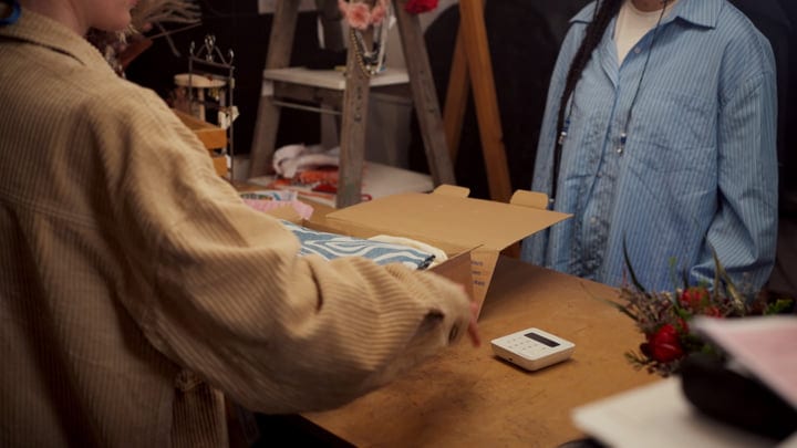 Hands Wrap Gifts In Cozy Boutique Setting