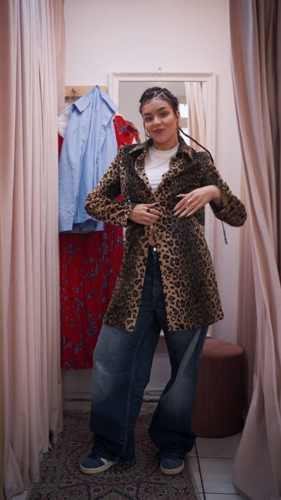 Confident Shopper Models Leopard Coat In Chic Boutique