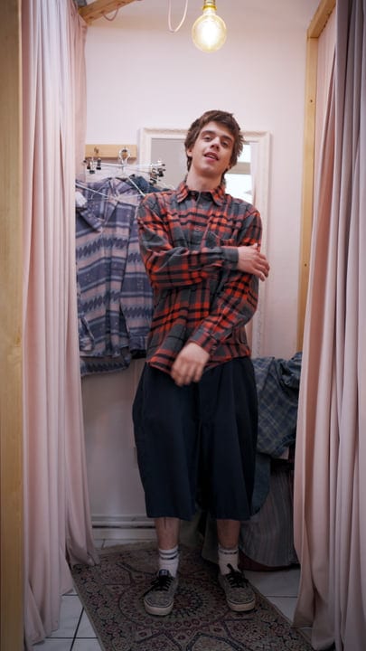 A Young Shopper Embraces Style In A Cozy Boutique