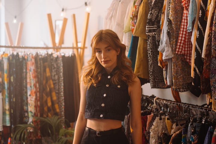 Young Woman Embracing Style In Vibrant Boutique Setting