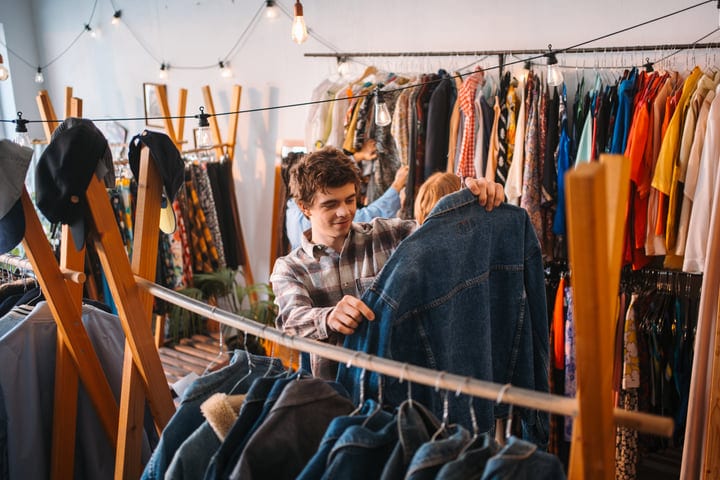 Young Man Curates His Style In A Cozy Boutique