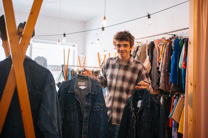 Young Shopper Enjoys Denim Selections In Quaint Boutique