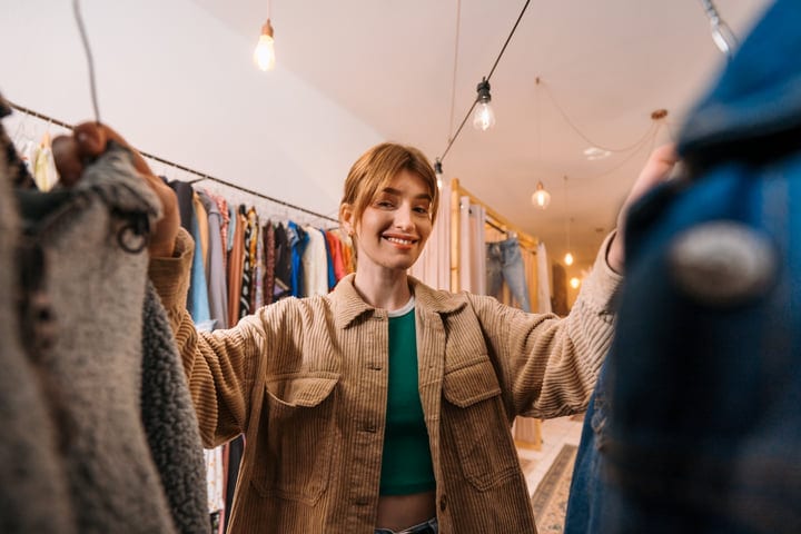 Young Woman Embraces Boutique Finds With Joyful Enthusiasm