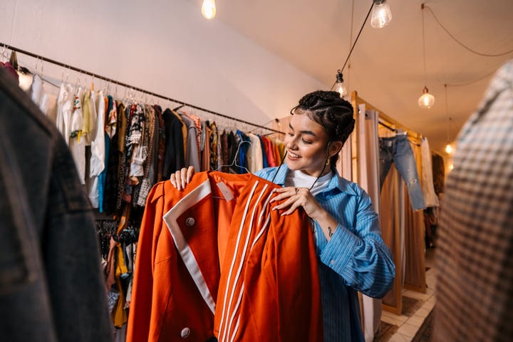 Joyful Discovery Of Vibrant Jacket In Boutique Setting