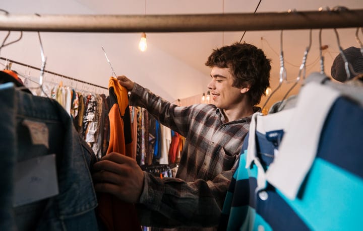 Young Shopper Discovers Hidden Gems In A Cozy Boutique