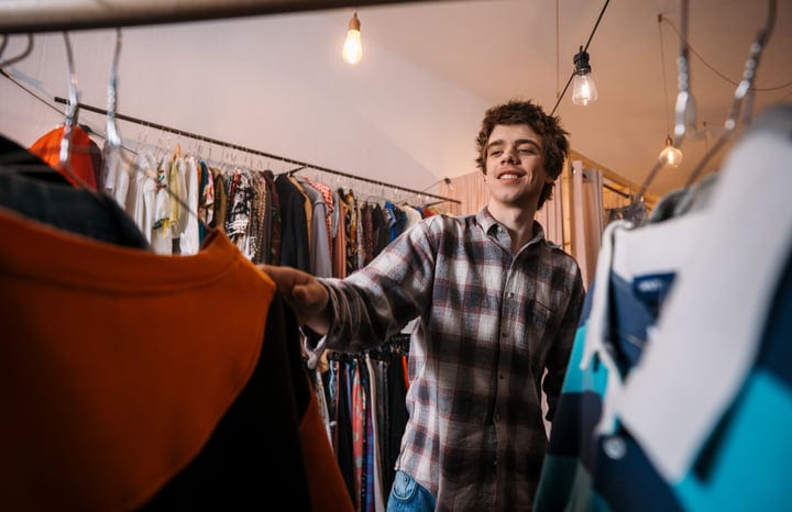 Young Man Delights In Boutique Shopping Adventure