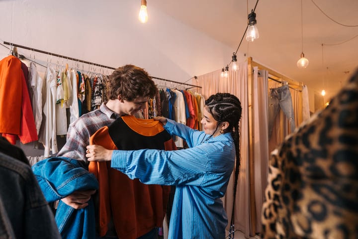 Friends Share Laughter While Shopping For Stylish Outfits
