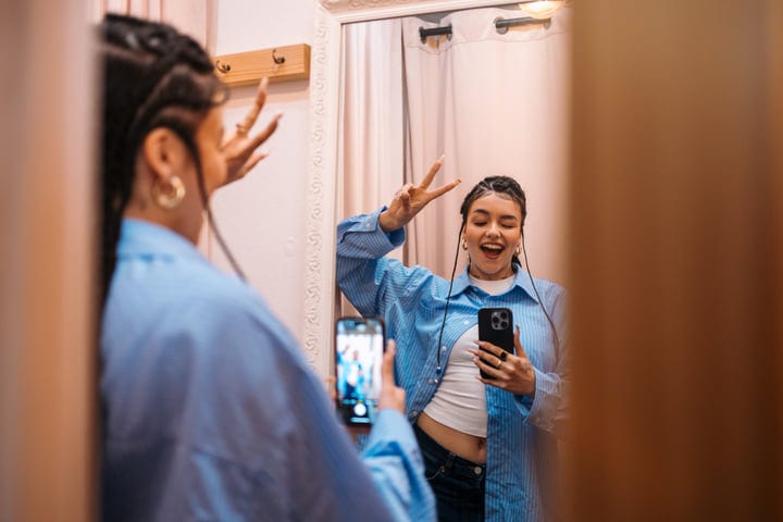 Capturing Joy In A Boutique's Dressing Room Mirror