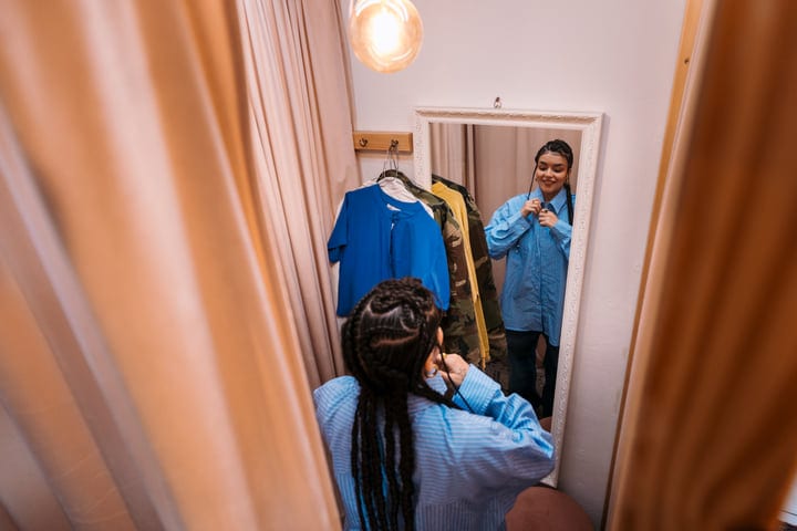 Young Friends Sharing Fashion Moments In A Boutique Fitting Room