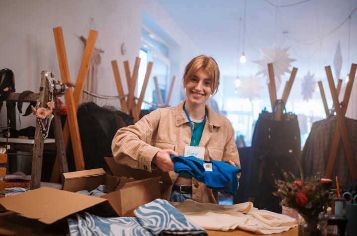 Joyful Moment Unpacking New Clothes In Boutique