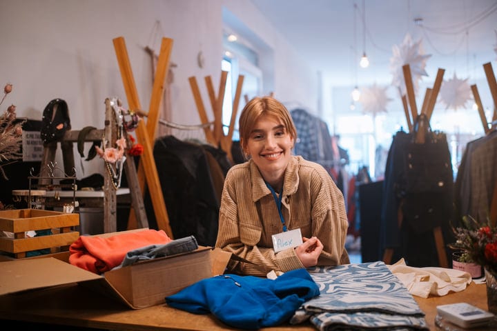 Friendly Boutique Atmosphere with Smiling Shop Assistant