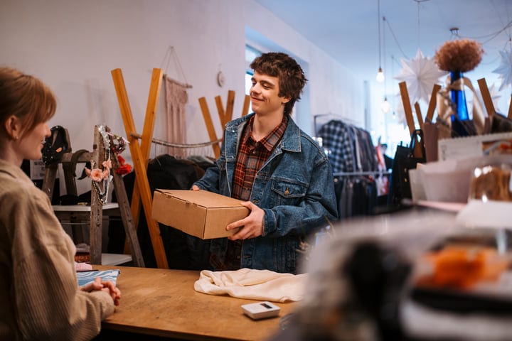 Joyful Exchange Between Friends In A Cozy Boutique