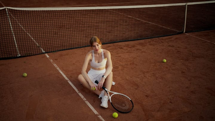 Contemplative Pause On The Clay Court At Sunset