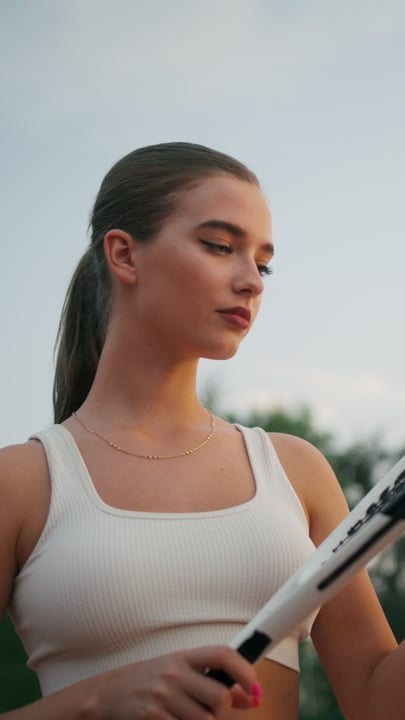 Close Up Of Female Tennis Player Holding Racket With Focused Gaze