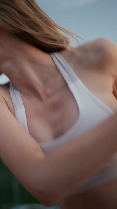Close-Up Of A Woman's Upper Body In Action During A Tennis Serve