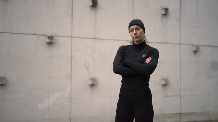 Woman In Black Athletic Wear Standing With Arms Crossed