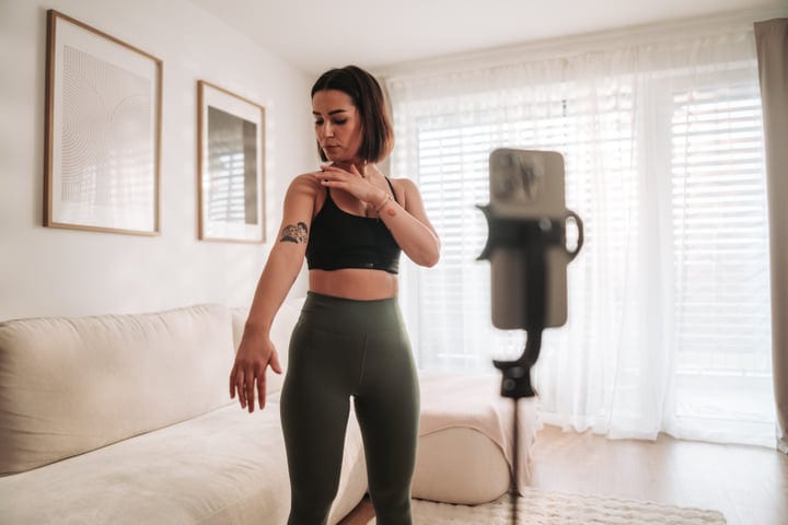 Young Woman Stretching Her Shoulder During A Morning Home Workout Session