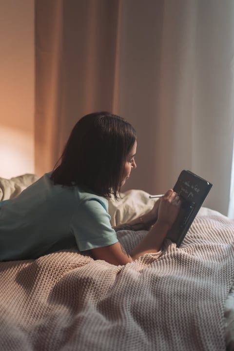 A Calm Morning: Woman's Digital Start In Bed