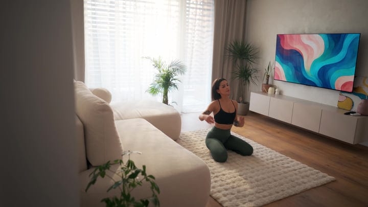 Young Woman Meditating On A Plush Rug In Bright Morning Living Room Light