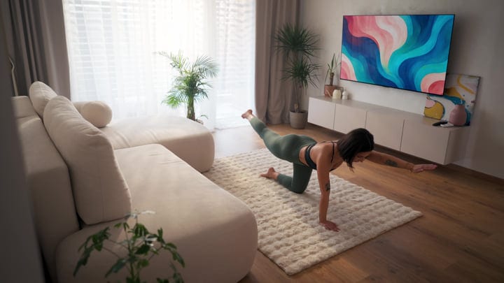 Woman Doing Core Strengthening Exercise On Rug In Her Bright Home