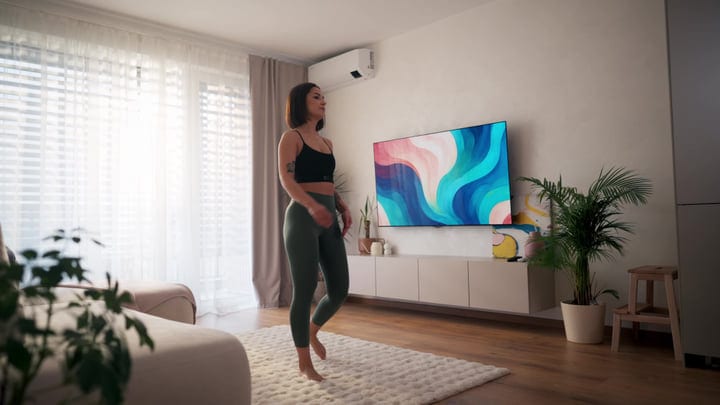 Young European Woman Standing Barefoot in Her Bright Modern Living Room