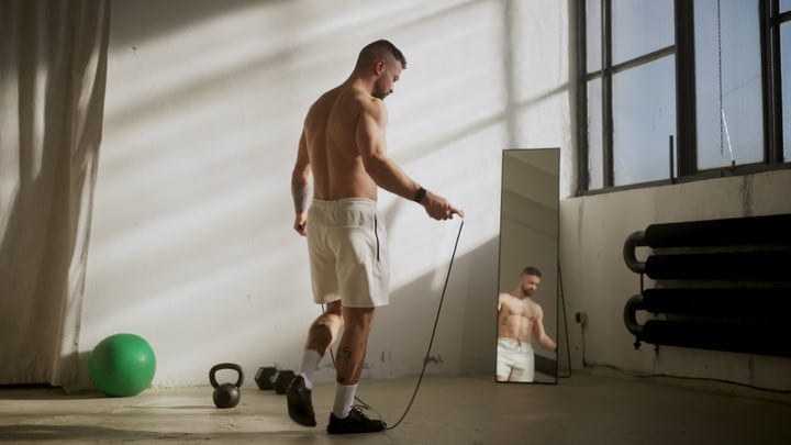 Muscular Man Jumps Rope During Intense Indoor Workout In Bright Studio