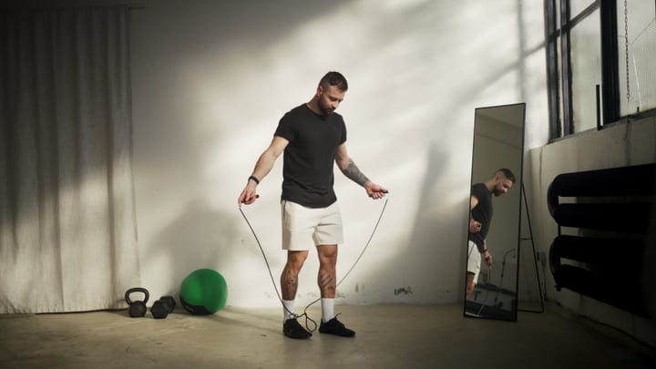 Man Skipping Rope During Indoor Workout In A Modern Fitness Studio