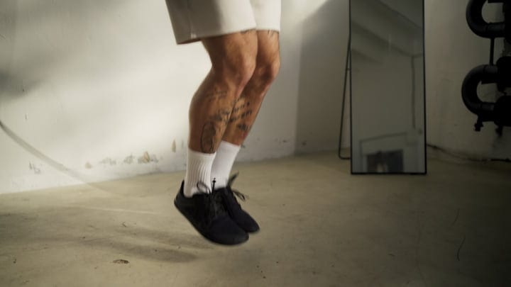 Athlete's Legs Powerfully Skipping Rope During An Intense Indoor Workout Session