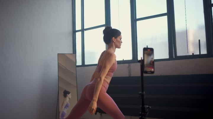 Woman In Pink Activewear Doing Yoga Lunge Pose In Modern Studio