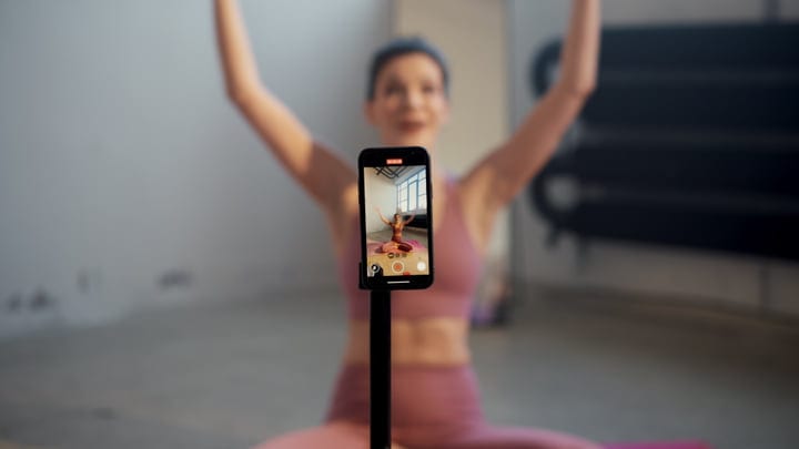 Young Woman Records Her Online Yoga Practice In A Minimalist Home Studio