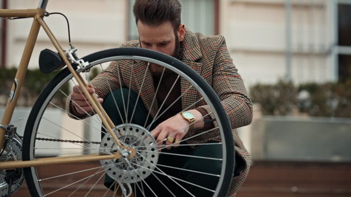 Businessman Adjusts His Bicycle On Urban Commute