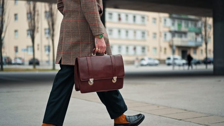 Stylish Businessman Walking With Leather Briefcase In City