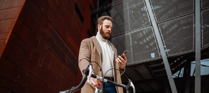 Businessman Navigates City Streets With His Smartphone
