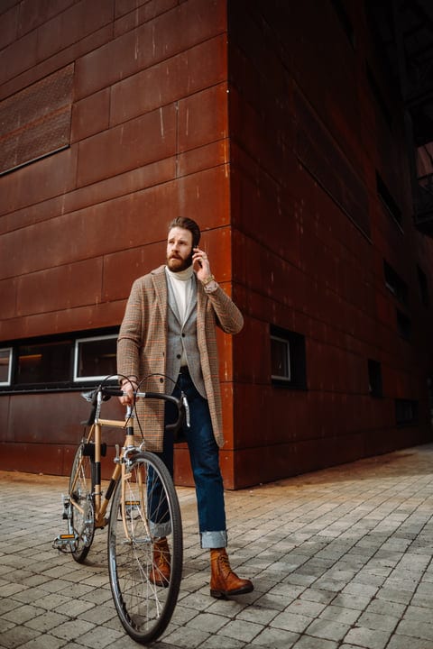 Confident Businessman Walks Urban Streets With Bicycle