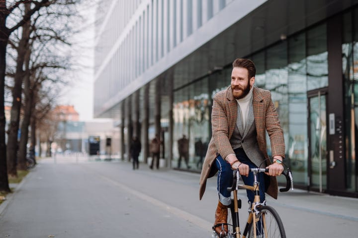 Urban Elegance: Businessman Cycling Through City Streets