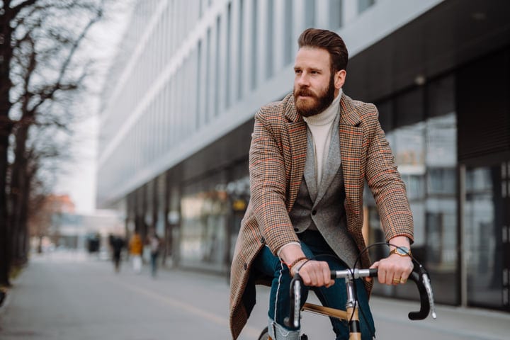 A Businessman Embraces Urban Cycling On A Crisp Morning