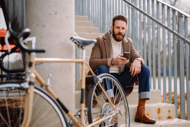 Chic Urban Commuter Takes a Break with Smartphone