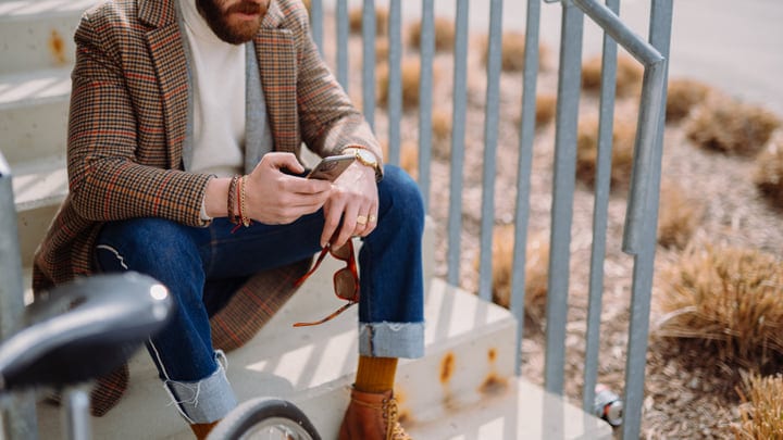 Urban Businessman Checks Messages During Autumn Commute
