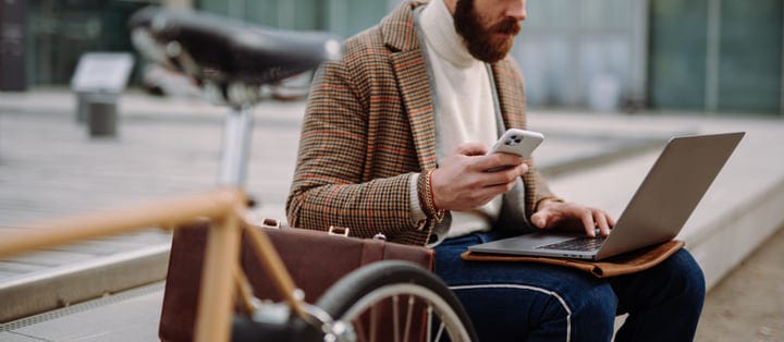 Businessman Balances Digital World On Urban Commute