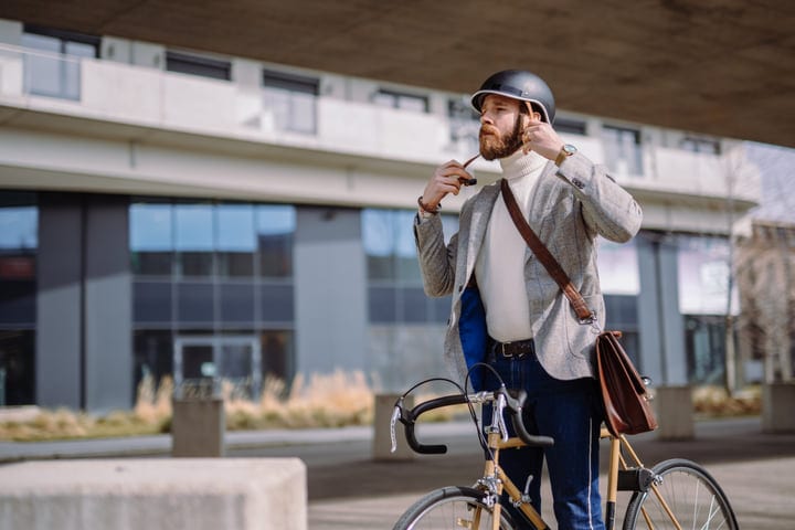Businessman Adjusts Helmet Before Cycling To Work