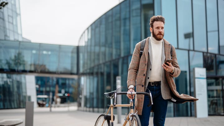 A Businessman Strolls With Purpose In Urban Setting
