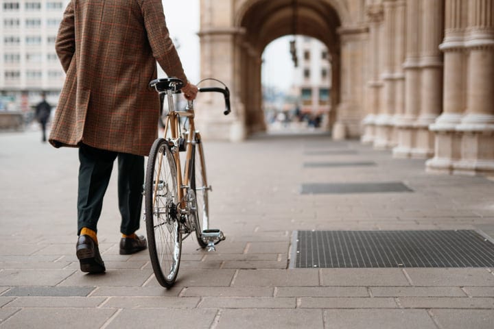 Autumn Commute: Businessman Navigating City Streets With Bicycle