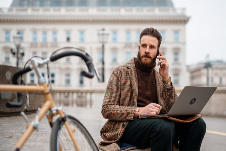 Modern Businessman Balances Work and Calls Outdoors