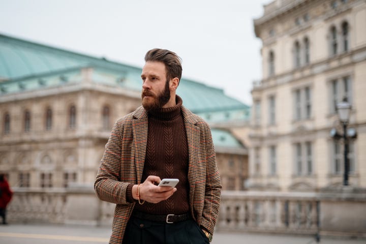 Stylish Businessman Navigating A European Urban Landscape