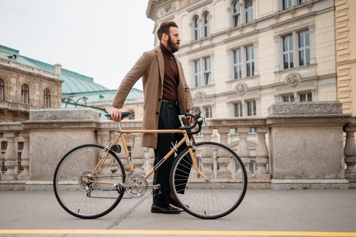 Confident Businessman Pausing With Bicycle In The City