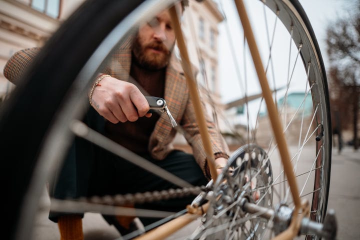 A Businessman's Hands Secure a Bike on City Streets