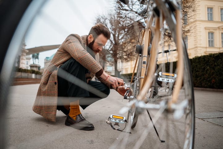 Businessman Fixes Bike During Urban Commute Adventure